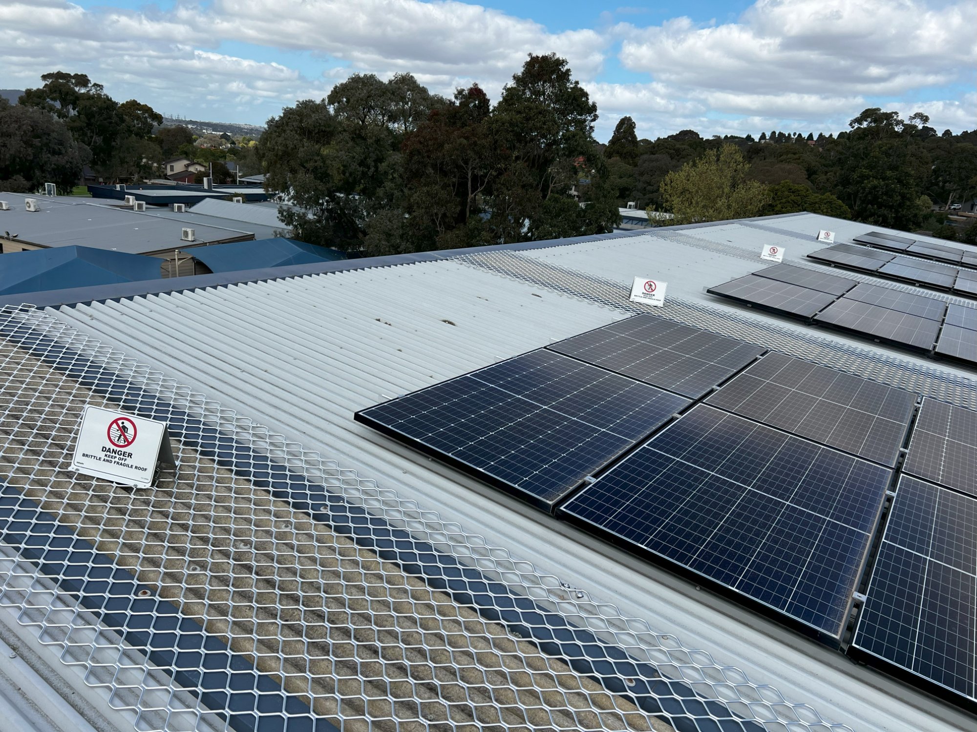 School rooftop with safety mesh and solar panels
