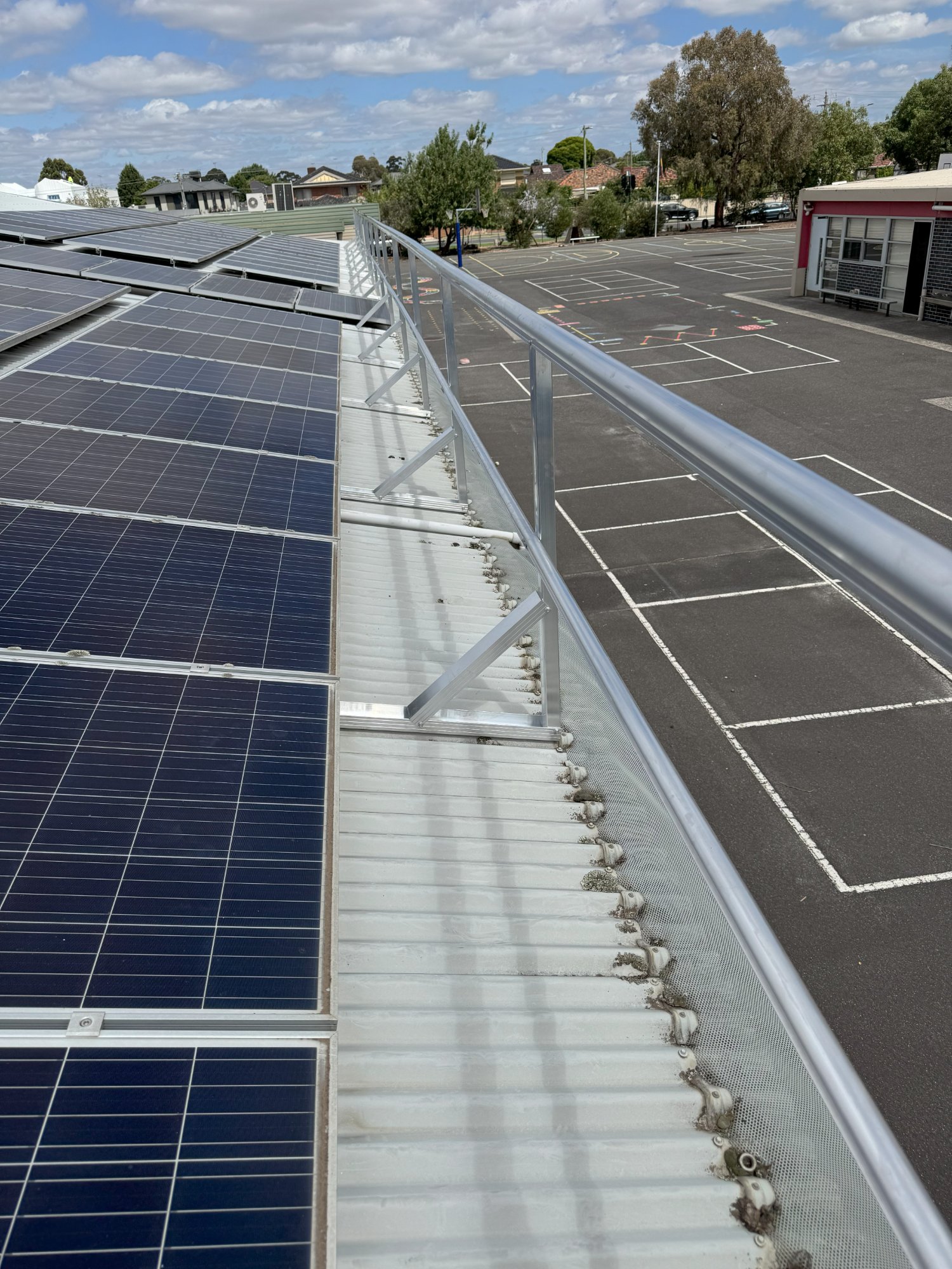 Height safety guardrail installation on school rooftop